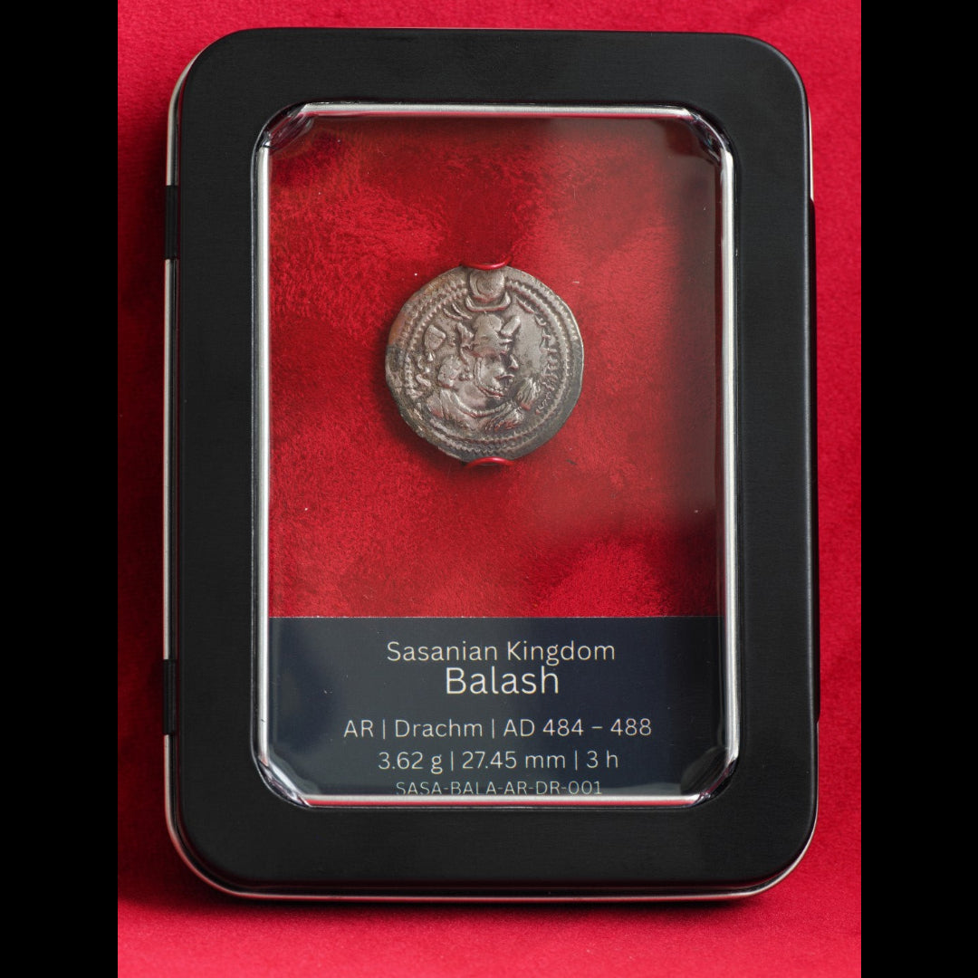 A Sasanian Kingdom Balash AR coin (AD 484-488) displayed inside a black protective case with a red velvet interior and a clear top cover. The case features a black label at the bottom with white text detailing the coin's specifications.